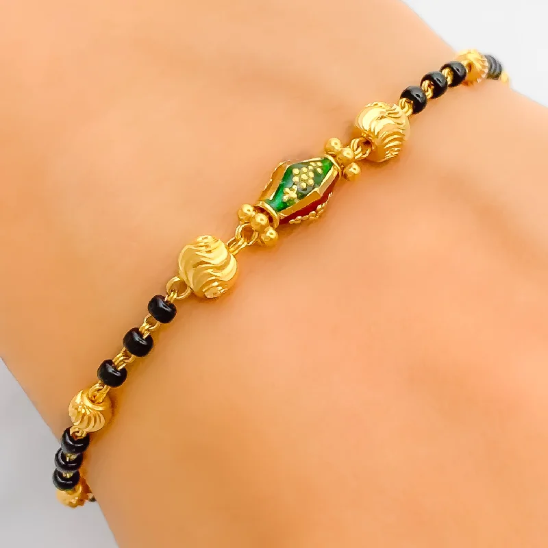 Women’s wedding bracelets-Vibrant Elongated Orb 22k Gold Black Bead Bracelet